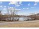 Picturesque lake view featuring a serene frozen lake, bare trees, and walking trail in the foreground at 9118 W 50Th Ln # 5, Arvada, CO 80002