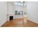 Bright living room featuring hardwood floors, fireplace, and a large window with shutters at 9118 W 50Th Ln # 5, Arvada, CO 80002