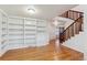 Bright living room with hardwood floors, built-in bookshelves, and an open staircase with wood railing at 9118 W 50Th Ln # 5, Arvada, CO 80002