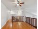 Loft area featuring hardwood floors and a wooden railing and a ceiling fan at 9118 W 50Th Ln # 5, Arvada, CO 80002