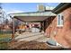 Covered patio with fire pit and access to backyard at 1585 Roslyn St, Denver, CO 80220