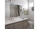 Elegant bathroom with a large mirror, vanity with storage, and a shower/tub combo at 6153 N Ceylon St # 102, Denver, CO 80249