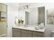 Clean bathroom with a large mirror, modern vanity, and neutral color scheme at 6153 N Ceylon St # 102, Denver, CO 80249