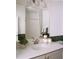 Well-lit bathroom with a vanity featuring storage, a stylish mirror, and a shower with tub at 6153 N Ceylon St # 102, Denver, CO 80249