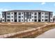Contemporary apartment building showcasing a stylish exterior with balconies and neat landscaping at 6153 N Ceylon St # 102, Denver, CO 80249
