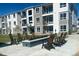 Outdoor seating area with Adirondack chairs surrounding a fire pit for relaxing evenings outdoors at 6153 N Ceylon St # 102, Denver, CO 80249
