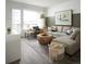 Bright living room featuring a sectional sofa, modern décor, and a large window with outdoor views at 6153 N Ceylon St # 102, Denver, CO 80249