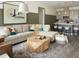 Comfortable living room with a large sectional sofa, modern coffee table, and open access to the kitchen at 6153 N Ceylon St # 102, Denver, CO 80249