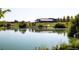 Picturesque pond at the community with lush greenery, trees, and walking path in the background at 6153 N Ceylon St # 102, Denver, CO 80249