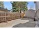 Fenced backyard features a storage shed and a concrete patio at 9590 W Eureka Pl, Lakewood, CO 80227