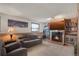 Finished basement offering a cozy fireplace, built-in bookshelves, and ample seating, perfect for relaxation at 9590 W Eureka Pl, Lakewood, CO 80227