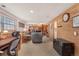 Spacious basement featuring wood paneling, a fireplace, and comfortable seating area at 9590 W Eureka Pl, Lakewood, CO 80227