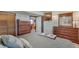 Cozy bedroom with wooden furniture, soft lighting, and comfortable bedding at 9590 W Eureka Pl, Lakewood, CO 80227