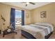 Comfortable bedroom with large window, ceiling fan, and ample natural light at 9590 W Eureka Pl, Lakewood, CO 80227