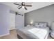 Comfortable bedroom with gray walls, light wood floors, and a ceiling fan at 9590 W Eureka Pl, Lakewood, CO 80227