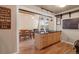 Spacious kitchen island with wood cabinets and black countertop adjacent to a dining area at 9590 W Eureka Pl, Lakewood, CO 80227