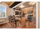 Charming kitchen featuring an island with bar seating, stainless steel appliances, and custom wood cabinets at 9590 W Eureka Pl, Lakewood, CO 80227