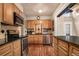 Functional kitchen with stainless steel appliances, custom cabinetry and stylish backsplash at 9590 W Eureka Pl, Lakewood, CO 80227
