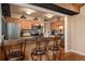 Open kitchen featuring a breakfast bar with seating, stainless steel appliances, and modern lighting at 9590 W Eureka Pl, Lakewood, CO 80227