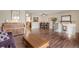 Spacious living area with hardwood floors, piano, and view of staircase and dining area at 9590 W Eureka Pl, Lakewood, CO 80227