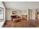 Inviting living room featuring hardwood floors, neutral paint tones, and ample natural light creating a warm ambiance at 9590 W Eureka Pl, Lakewood, CO 80227