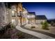 Beautifully landscaped backyard featuring a stone walkway leading to a patio with fire pit at 13176 Frannys Way, Parker, CO 80138