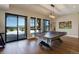 Finished basement featuring a pool table, hardwood floors, and walkout to a patio area at 13176 Frannys Way, Parker, CO 80138