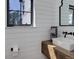 Chic powder room featuring modern fixtures, shiplap walls, and a floating wood vanity at 13176 Frannys Way, Parker, CO 80138