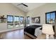Sunlit bedroom with vaulted ceilings, large windows, and hardwood floors at 13176 Frannys Way, Parker, CO 80138