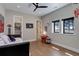 Comfortable bedroom with a walk-in closet, wood floors and a ceiling fan at 13176 Frannys Way, Parker, CO 80138