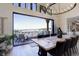 Open dining area with wood floors, modern chandelier, and large sliding glass doors to outdoor deck with beautiful views at 13176 Frannys Way, Parker, CO 80138
