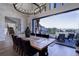 Elegant dining room with stone accent wall, wood floors, and sliding doors to outdoor patio with views at 13176 Frannys Way, Parker, CO 80138