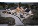 Gorgeous home featuring an oversized driveway, pristine landscaping, patio with fireplace, and outdoor living spaces at 13176 Frannys Way, Parker, CO 80138