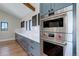 Modern kitchen featuring stainless steel oven and microwave with ample counter space and stylish cabinetry at 13176 Frannys Way, Parker, CO 80138