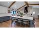 Stylish kitchen with a large island, farmhouse sink, custom cabinets and modern appliances at 13176 Frannys Way, Parker, CO 80138