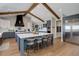 Gourmet kitchen featuring dual islands, stainless steel appliances, custom cabinets and beautiful wood beam accents at 13176 Frannys Way, Parker, CO 80138