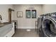 A bright laundry room with modern washer and dryer, custom cabinets, and plenty of counter space at 13176 Frannys Way, Parker, CO 80138