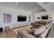 Spacious living room features a comfortable sectional sofa, large screen TV, and a stylish bar area at 13176 Frannys Way, Parker, CO 80138