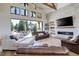 Bright living room with a cozy fireplace, neutral decor, and expansive windows offering stunning views of the outdoors at 13176 Frannys Way, Parker, CO 80138