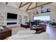 Open-concept living room featuring a vaulted ceiling, fireplace, and large windows showcasing stunning views at 13176 Frannys Way, Parker, CO 80138