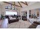 Spacious living room with vaulted ceilings, wood beams, comfortable seating, and views of the outdoor scenery at 13176 Frannys Way, Parker, CO 80138