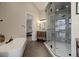 Main bathroom with oversized walk-in shower, dual vanities, and soaking tub at 13176 Frannys Way, Parker, CO 80138