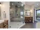 A spacious main bathroom has a large walk-in shower and sleek, modern fixtures and finishes at 13176 Frannys Way, Parker, CO 80138