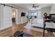 Bright main bedroom with hardwood floors and neutral color palette. View to bath and home gym area at 13176 Frannys Way, Parker, CO 80138