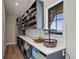 Well-organized pantry with ample shelving, counter space, storage cabinets, and a convenient beverage fridge at 13176 Frannys Way, Parker, CO 80138