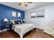 Bedroom with dark blue walls, hardwood floors, and a ceiling fan at 2042 S Josephine St # 2, Denver, CO 80210