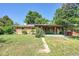 Relaxing backyard with beautiful foliage, covered patio, and open green space at 426 Kenton St, Aurora, CO 80010