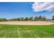 View of a baseball field with an infield, grass outfield and protective fencing at 426 Kenton St, Aurora, CO 80010