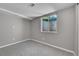 Basement bedroom featuring natural light and neutral colors, with cozy carpet at 426 Kenton St, Aurora, CO 80010