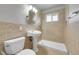 Updated bathroom showcasing tiled shower, vanity sink, toilet, and natural light at 426 Kenton St, Aurora, CO 80010